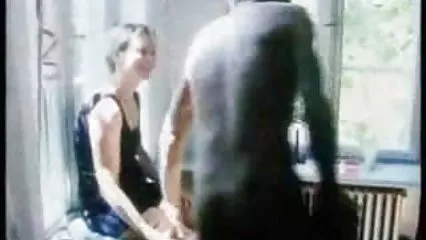 Big breasted black woman plays with her tits